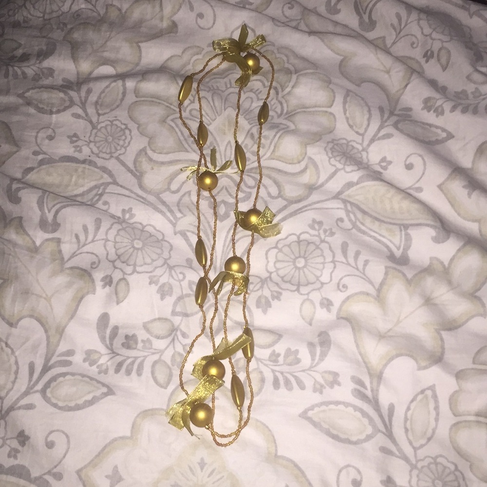 Pretty gold bead, bow, and ball necklace